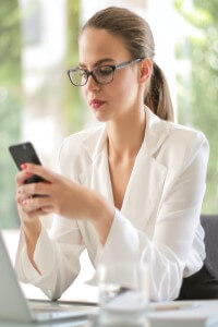 Woman at desk with cell